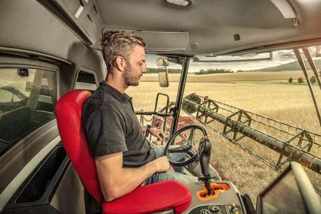 man in the cabin of a tractor