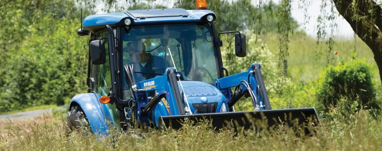 WORKMASTER utility tractor operates in tall grass