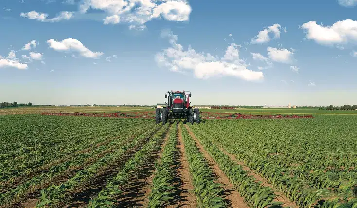 A tractor in a field with application equipment