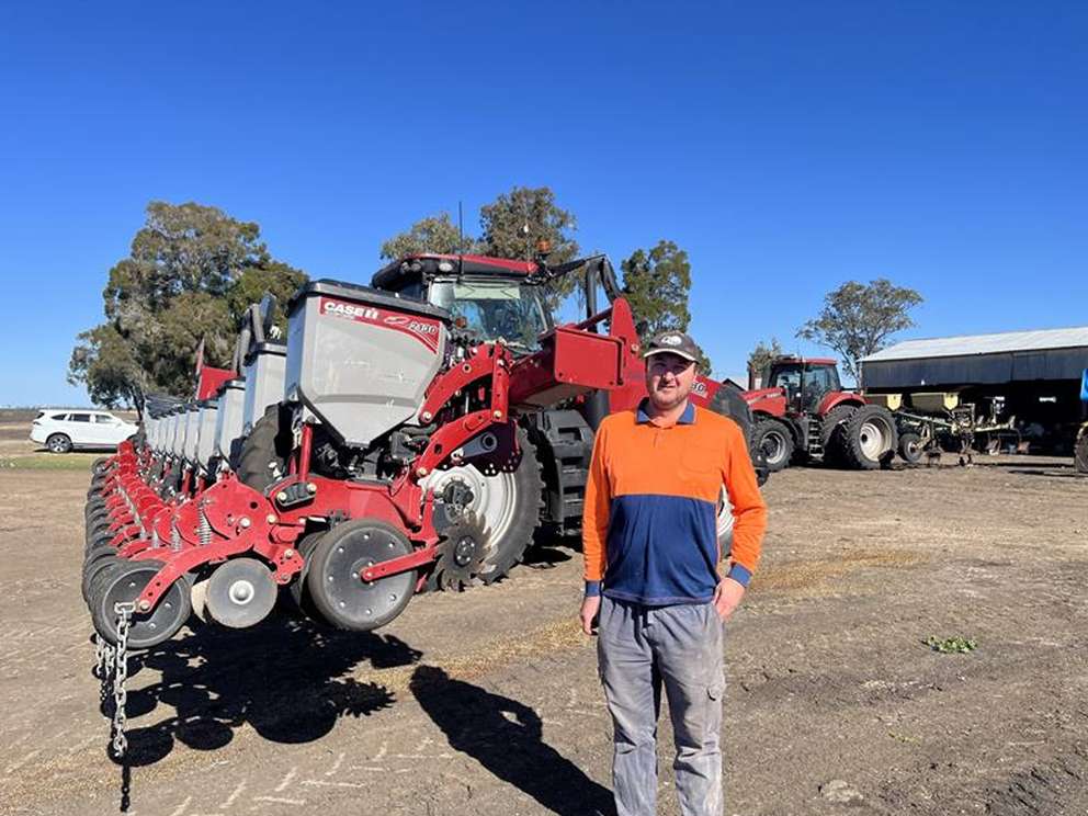 Happy customer in front of Case IH machinery in field
