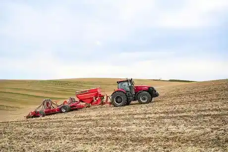 Magnum Series tractor working in field with attachment