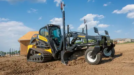 New Holland Construction C345 with precision grader blade attached.