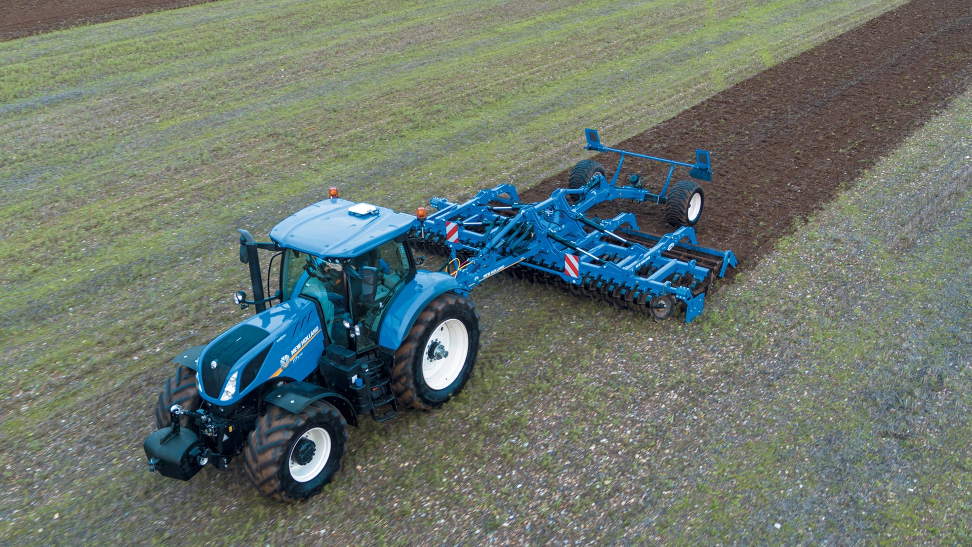 New Holland tractor employing SDM & SDH Disc Cultivators for soil preparation on agricultural land