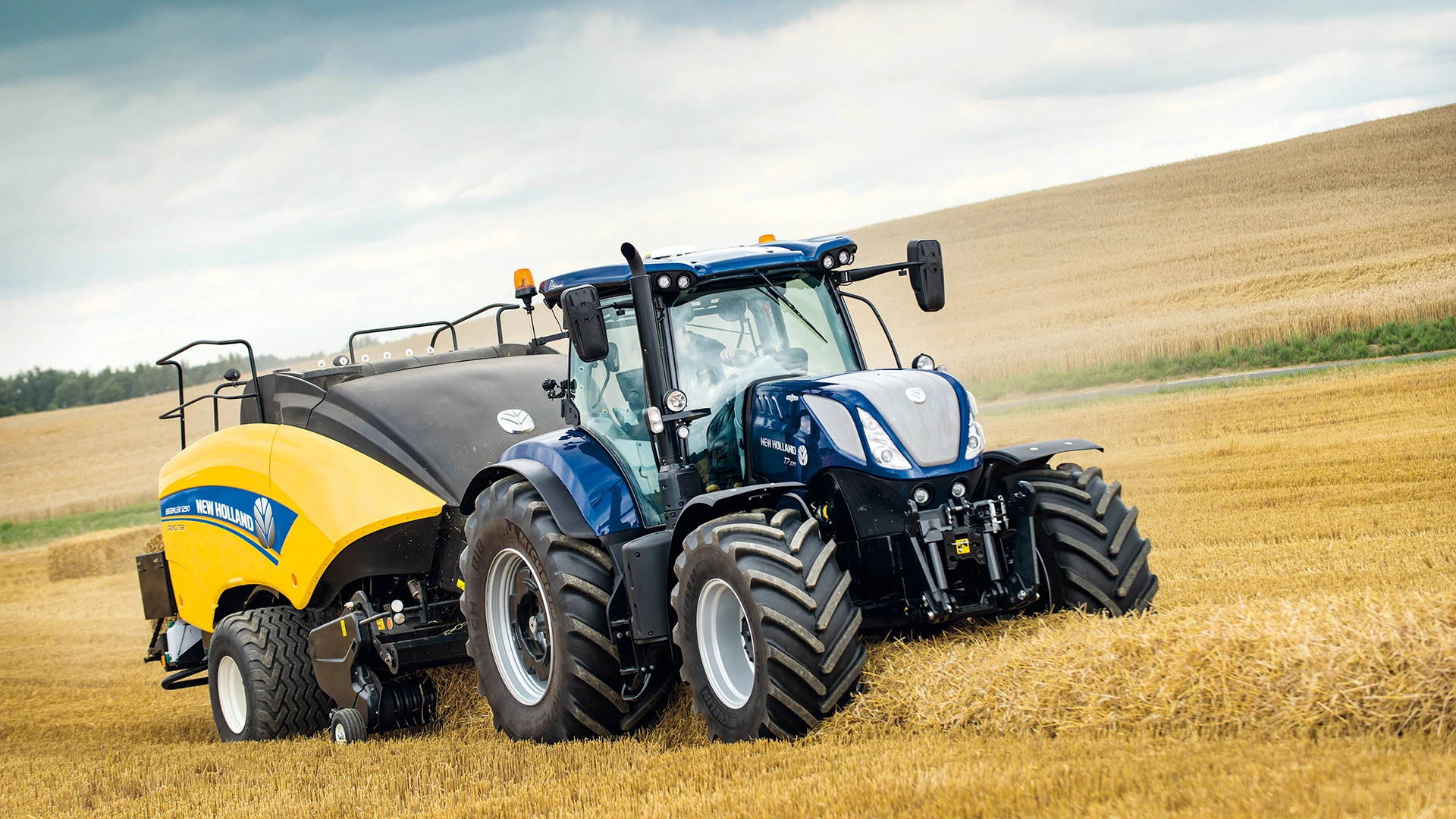 T7 SWB Tractor with a baler