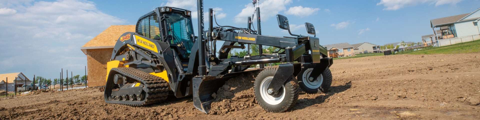 Compact track loader grading dirt.