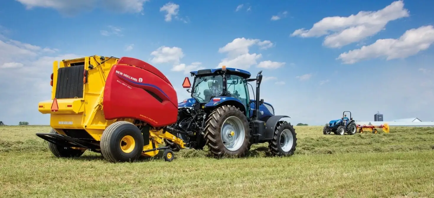 Roll-Belt™ Round Baler pulled by a New Holland tractor