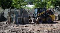 Skid Steer Loader lifting rocks.