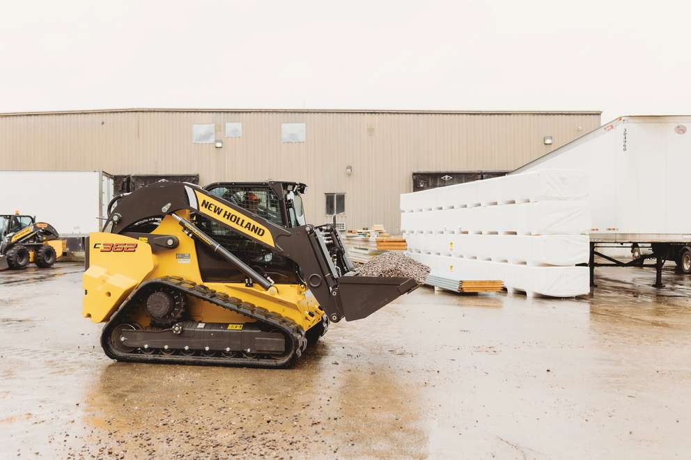 Compact Track Loader lifting materials.