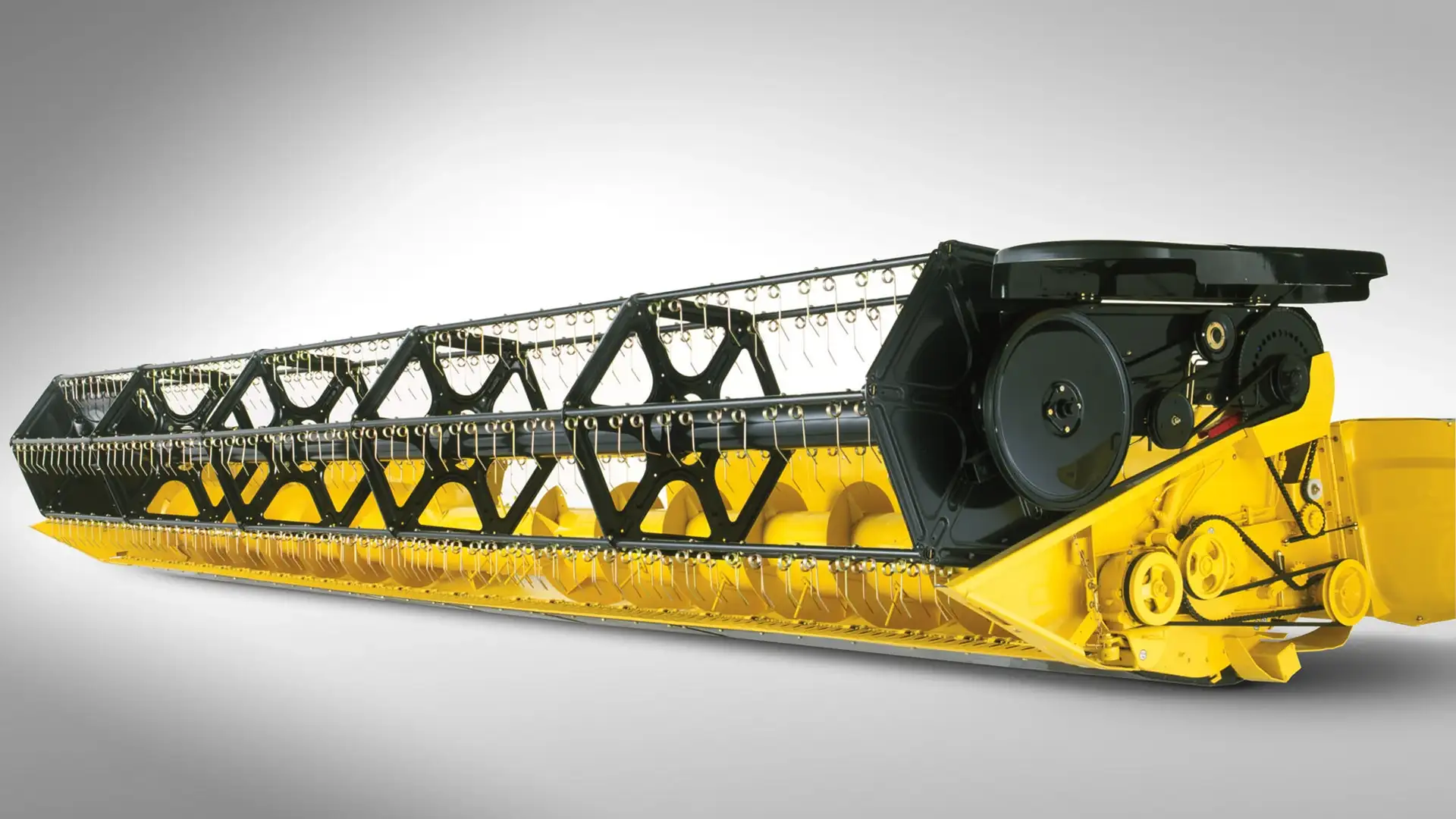 New Holland high capacity grain harvester header; sleek yellow design with detailed cutting blades, isolated view.