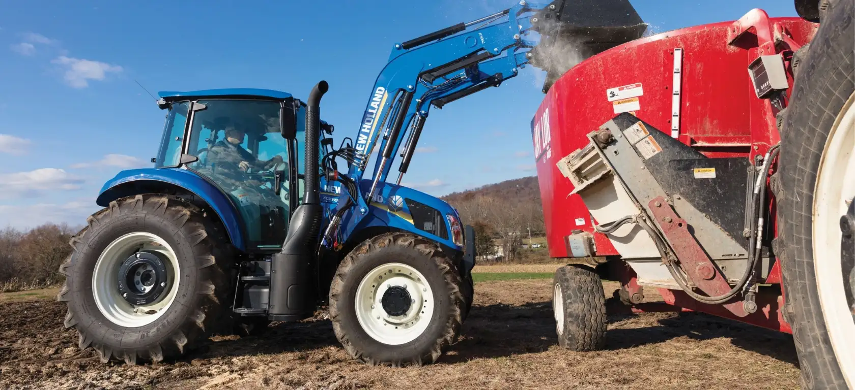 PowerStar Tractor dumps material with a front loader