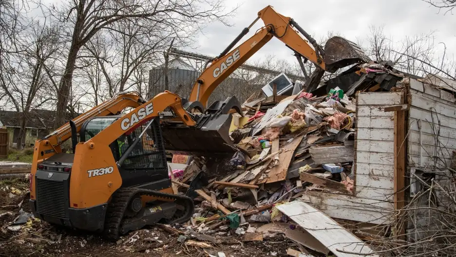 A CASE CTL and excavator are used to move scrap