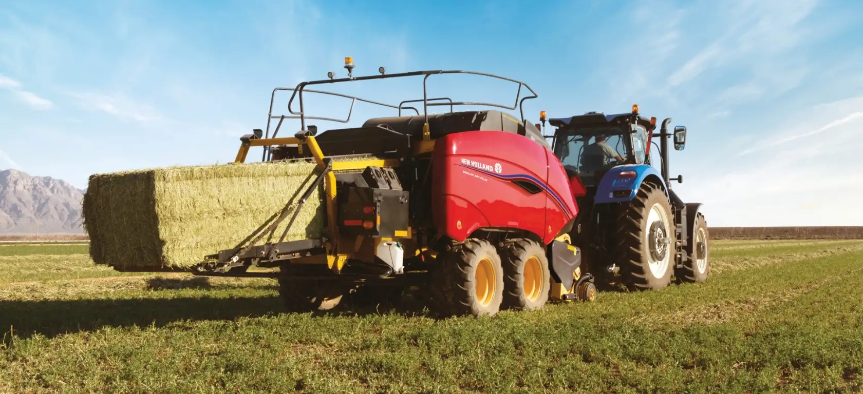 Tractor pulls a BigBaler PLUS Large Square Baler in the field
