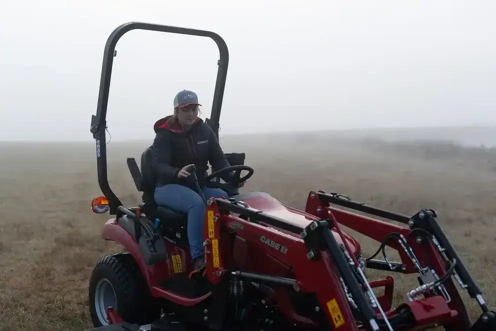 Case IH Farmall Subcompact tractor sitting in field with foggy background