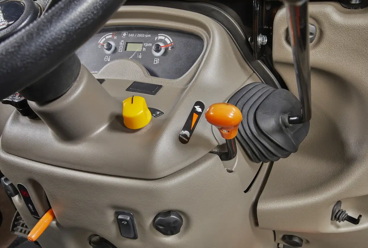 Close-up of a tractor's dashboard showcasing controls. 