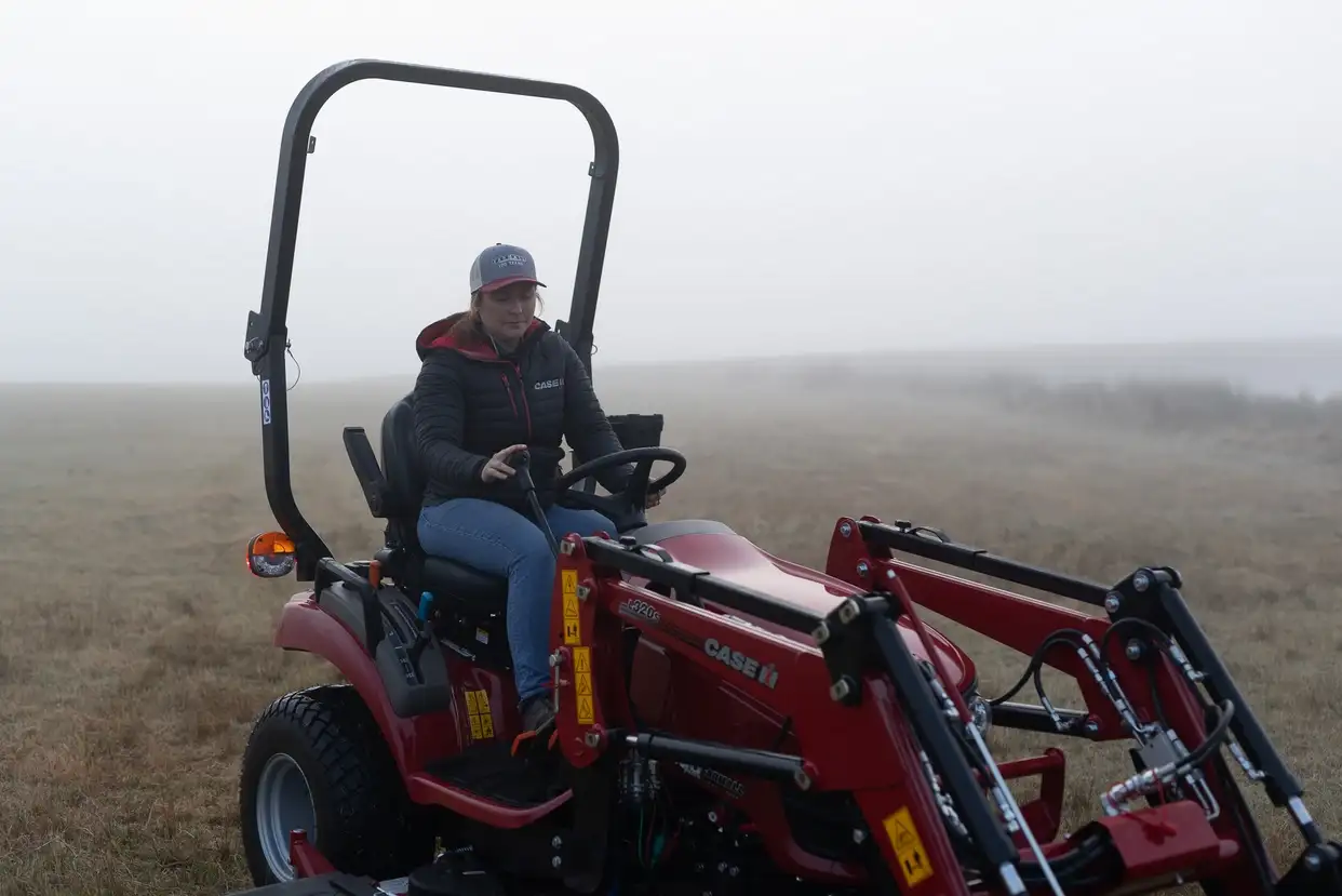 Case IH Farmall Subcompact tractor sitting in field with foggy background