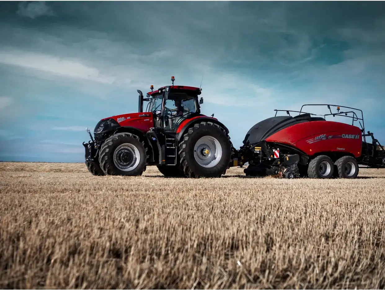 Case IH Optum 300 CVXDrive tractor with Case IH LB424 XLD large square baler working on a wheat stubble field