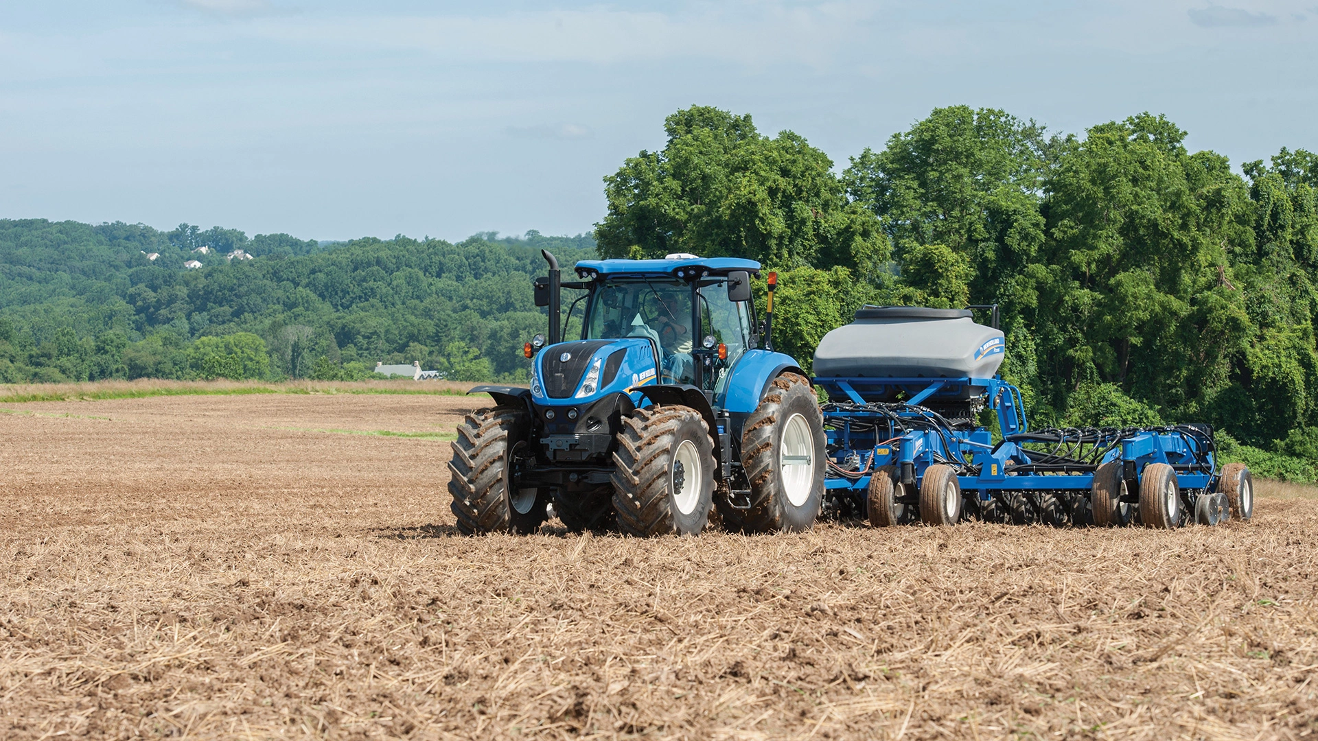 T7 Series tractor pulling a seeding implement