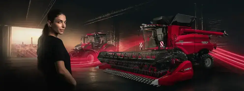A woman in a black T-shirt in the foreground, with a Case IH Axial-Flow 7160 combine harvester and a tractor behind her under dramatic red lighting