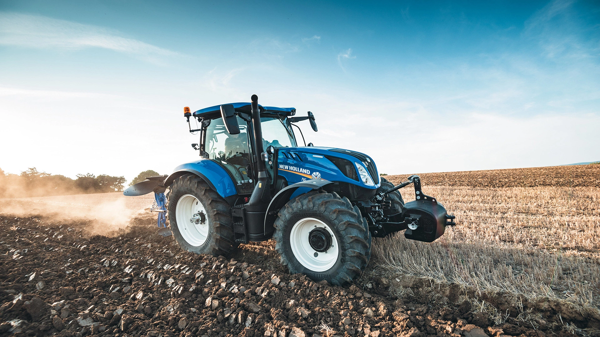 Tractor with New Holland's 6 furrow plough