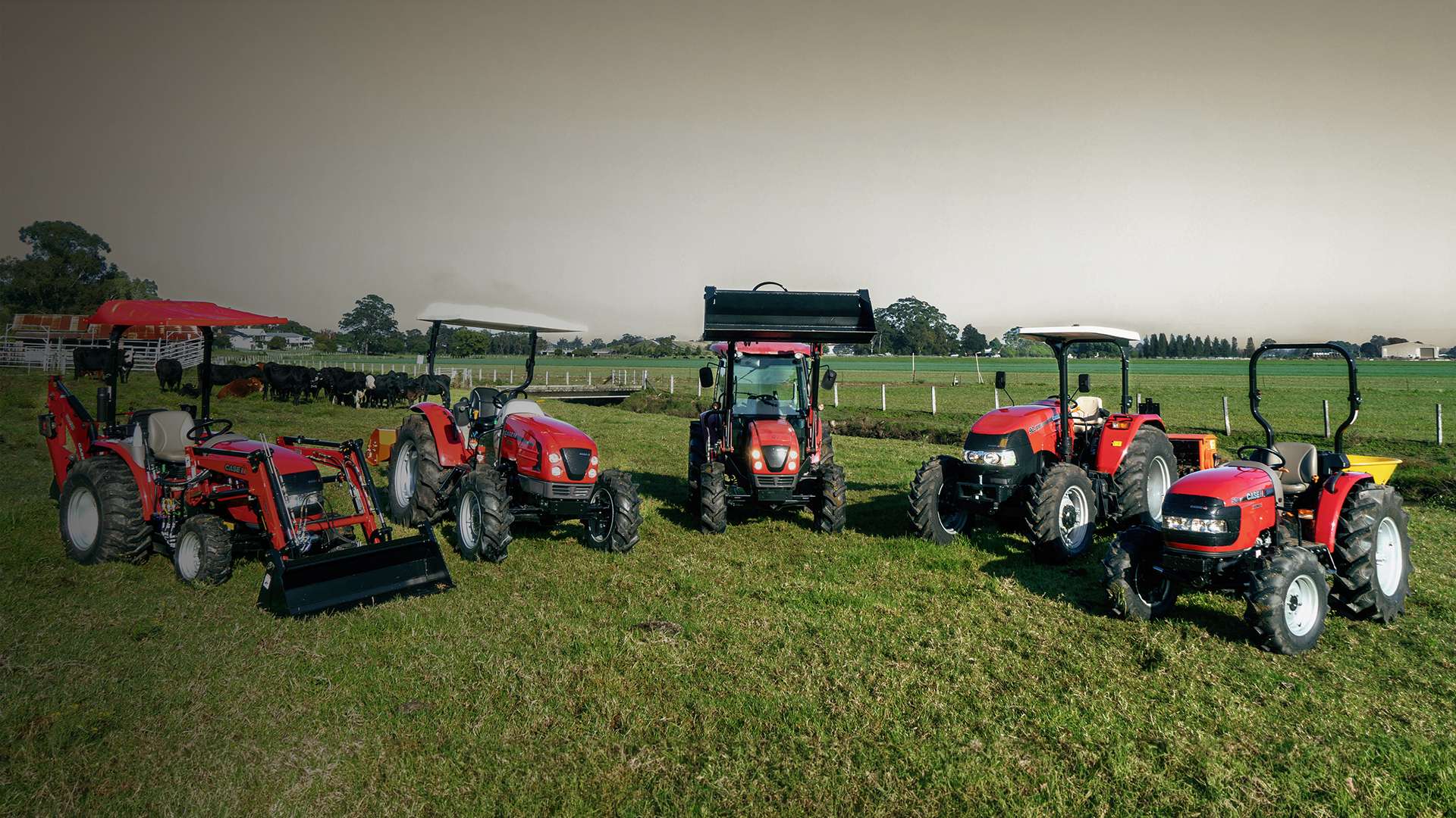 Red Case IH tractors sitting in field in a line up