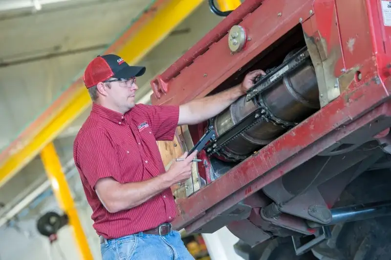 Case IH Technician examining Axial-Flow feeder chain