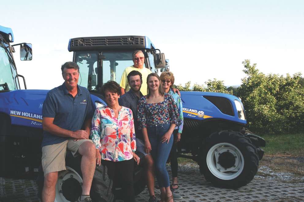 Family farmers pose in their orchard