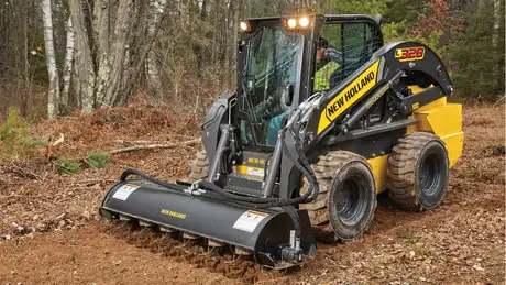 New Holland Construction L328 in woods.