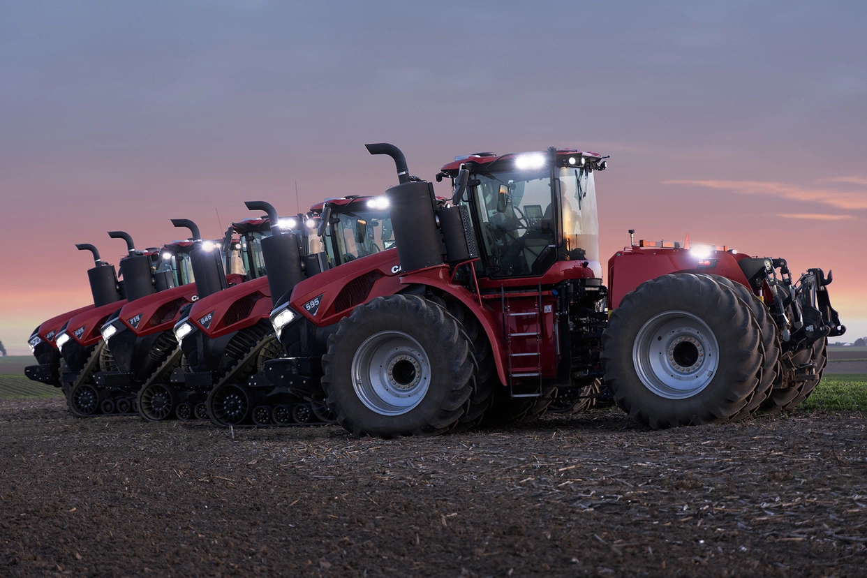 Steiger Family Tractors at dusk with lights on