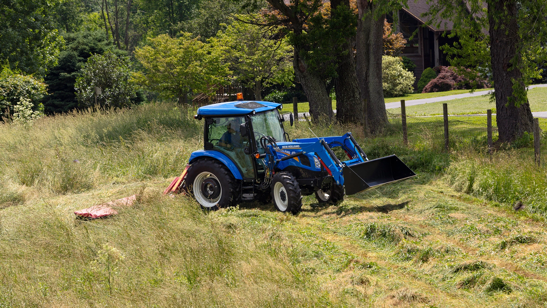 WORKMASTER tractor pulls a disc mower