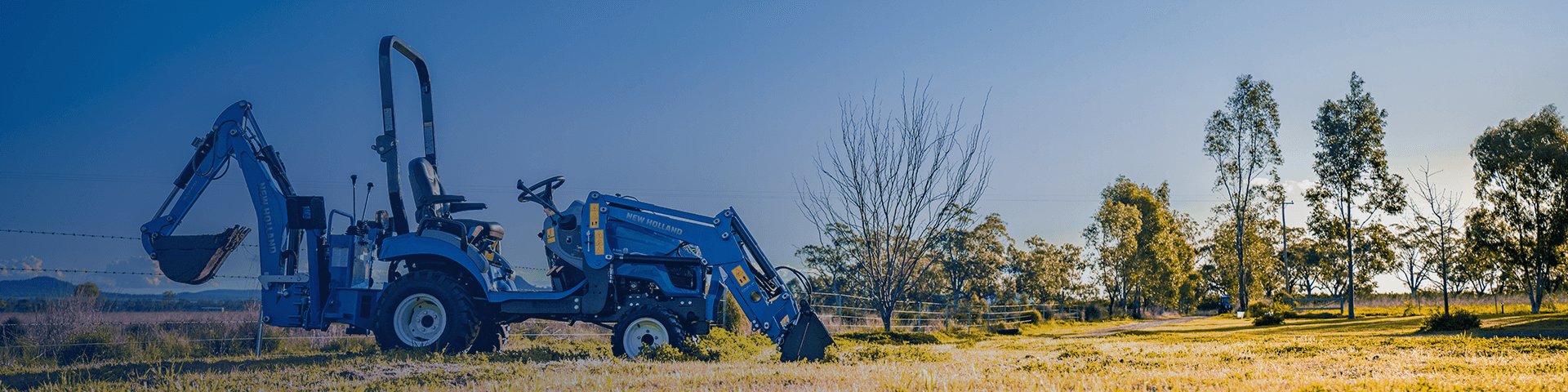 New Holland Boomer Series compact tractor sitting in field
