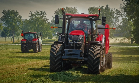 A Puma 260 tractor with a 456HD Pro Round Baler.