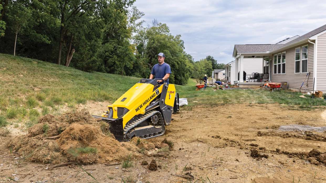 Mini Track Loader moving dirt.