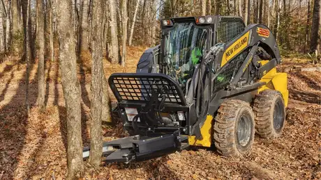 New Holland L328 cutting tree.