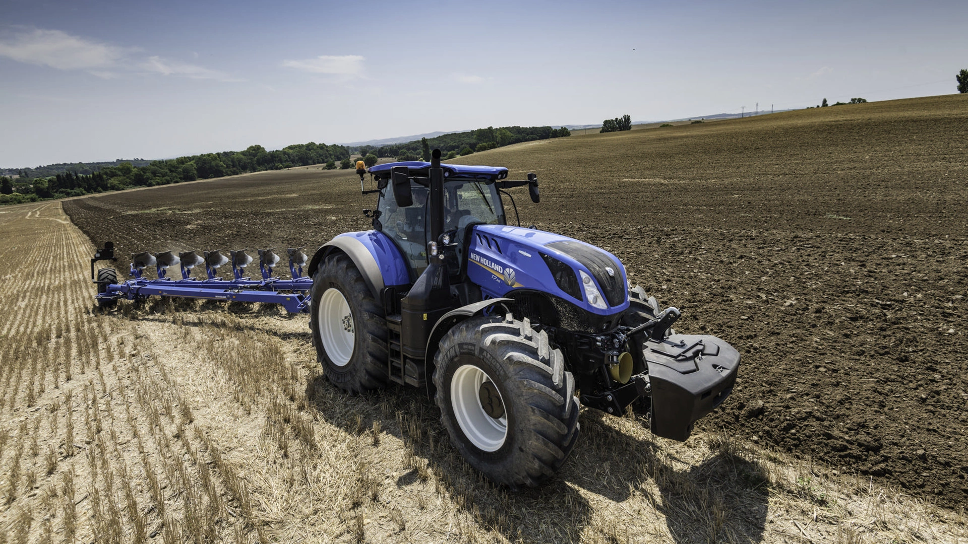 Tractor with 7 Furrow Semi-Mounted Variable Width Reversible Plough