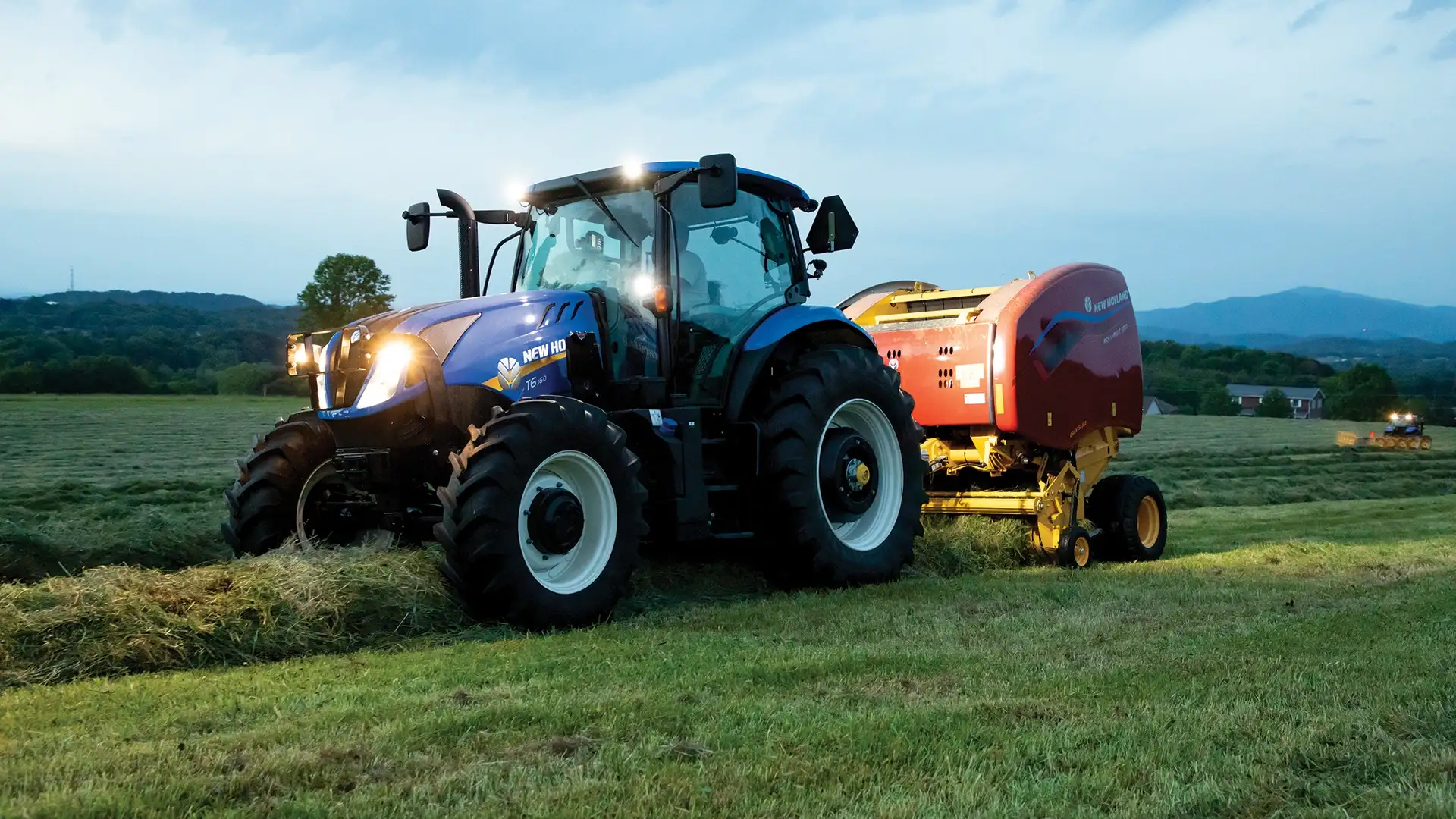 T6 Series tractor pulls a baler at night
