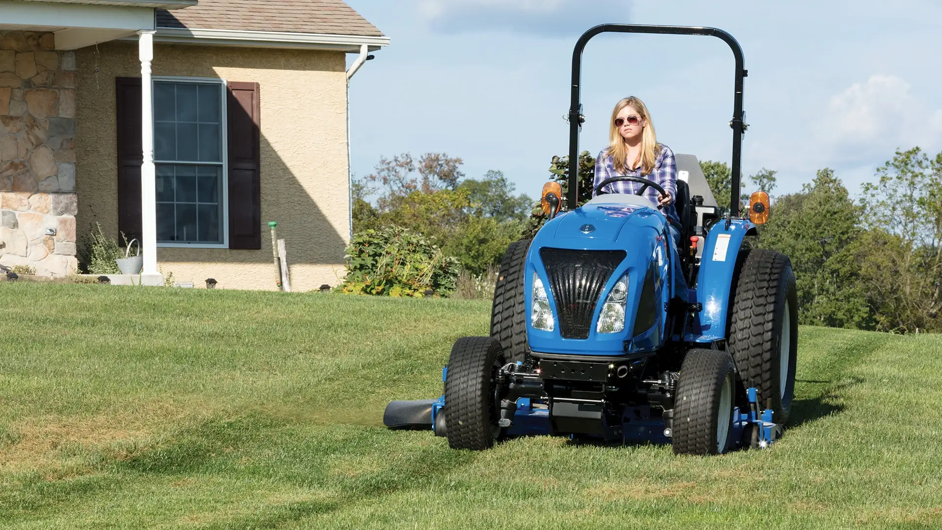 WORKMASTER compact tractor with mid-mount mower attachment