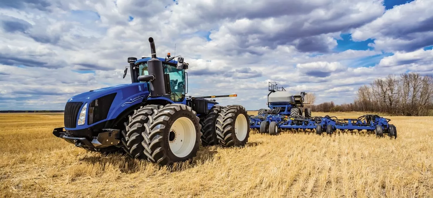 T9 tractor pulls a seeding implement in the field