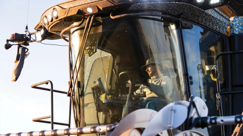 Man operates CR11 combine from inside the cab