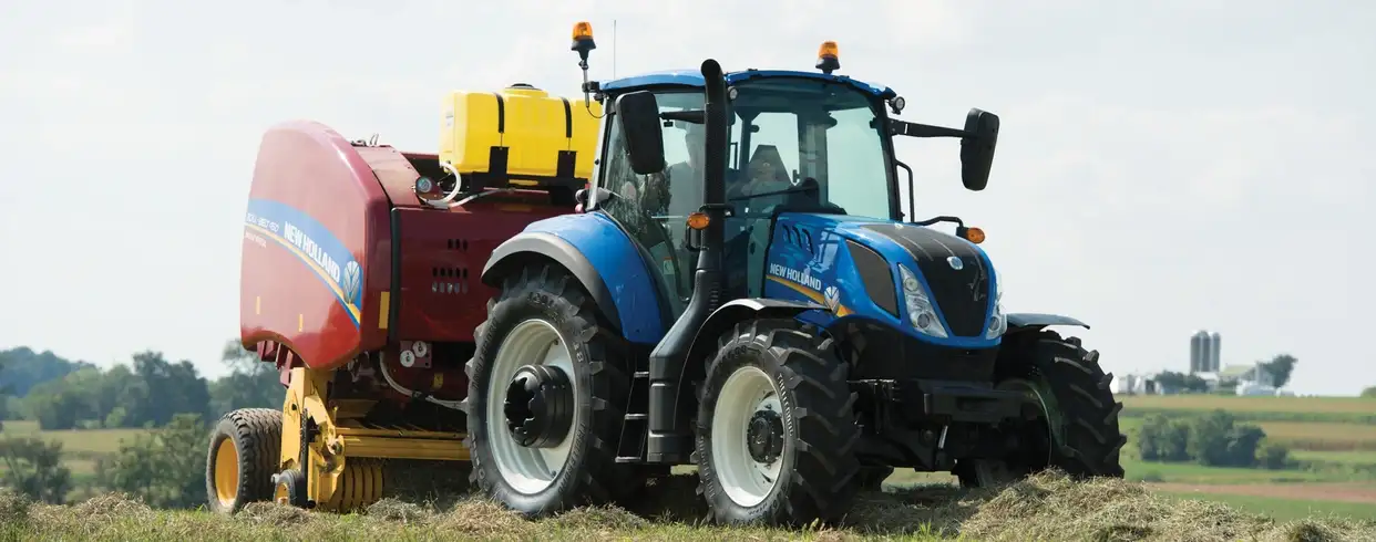 T5 Series tractor pulls a baler