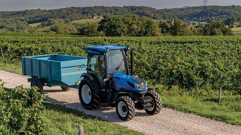 Blue New Holland T4 tractor in grass fields