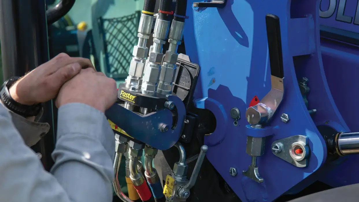 Hands adjusting hydraulic system.