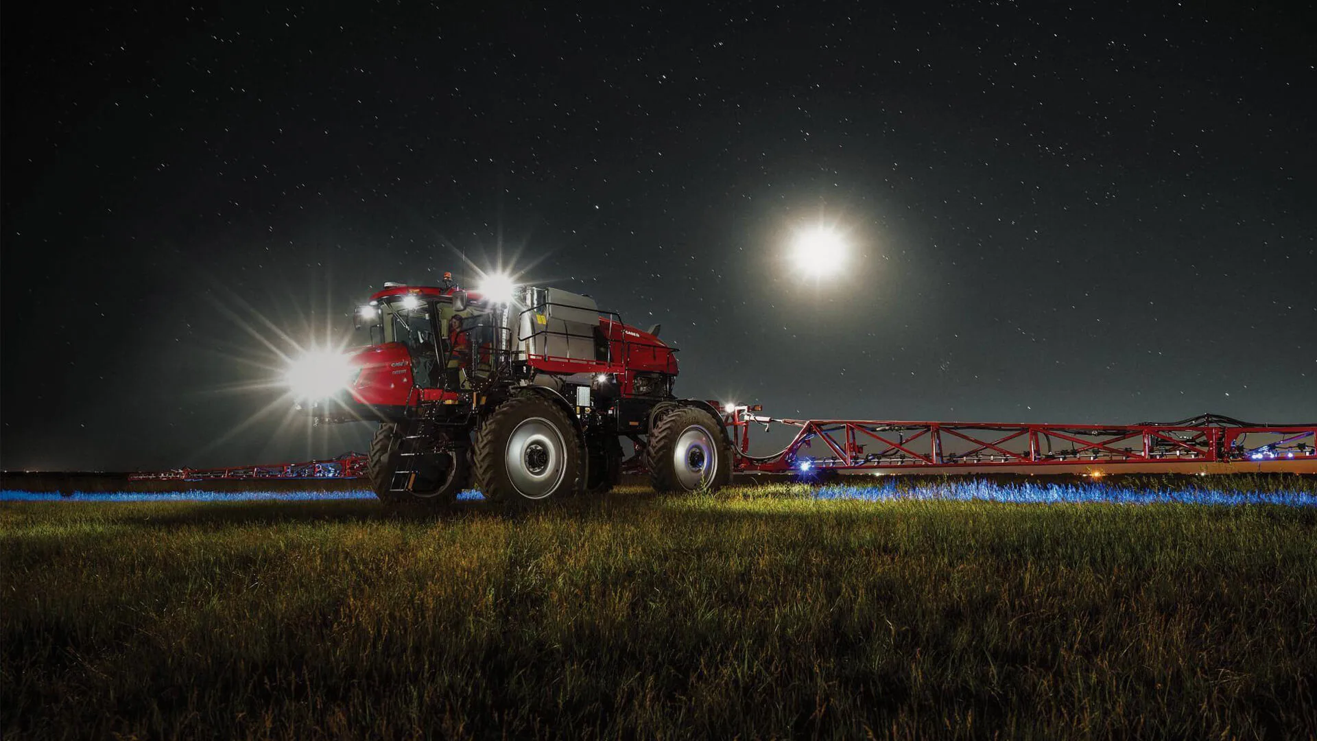 Case IH Patiot 50 Series Sprayer machine working in field at night time