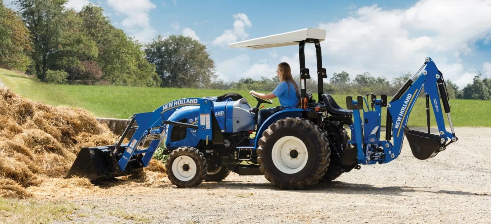 WORKMASTER tractor used for moving hay with a loader