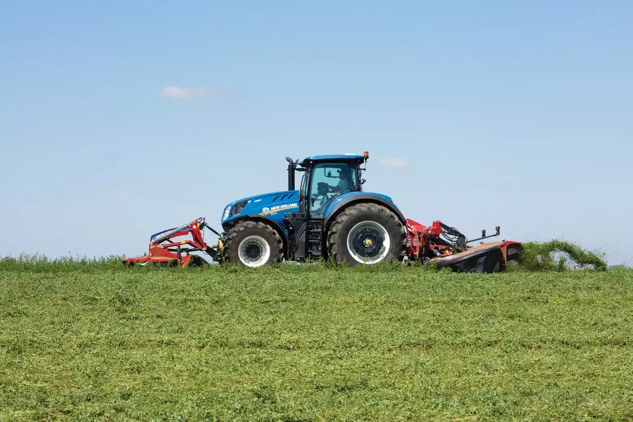 Tractor with a MegaCutter™ mounted disc mower and disc mower-conditioner