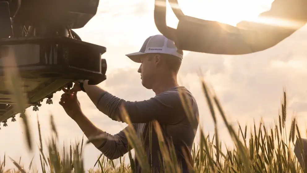 Man stands by New Holland Guardian Front-Boom Sprayer