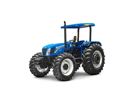 Trator New Holland TT azul com capota, plataforma aberta e pneus largos, visto em ângulo lateral-frontal.