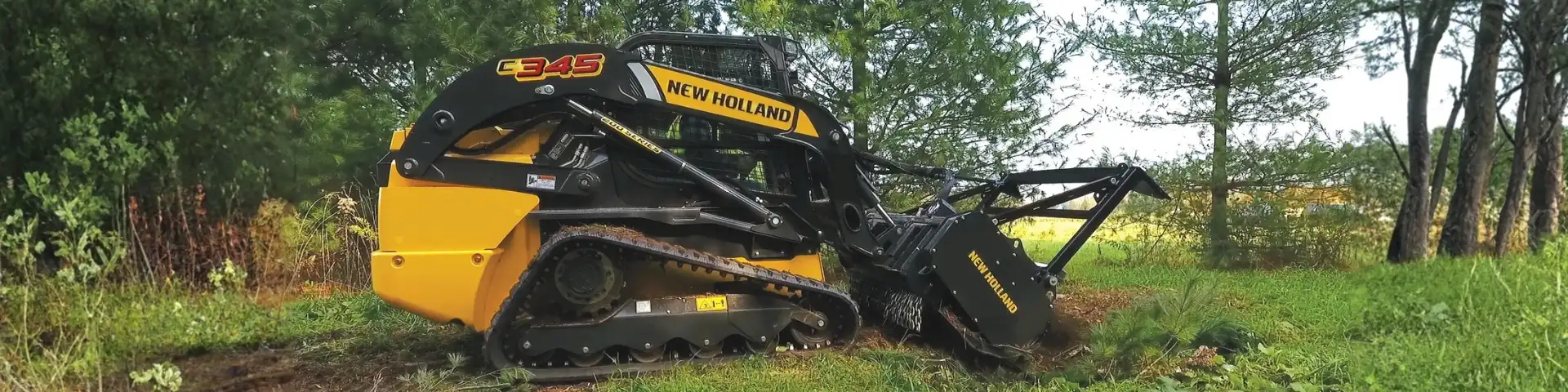 Compact track loader with mulchers.