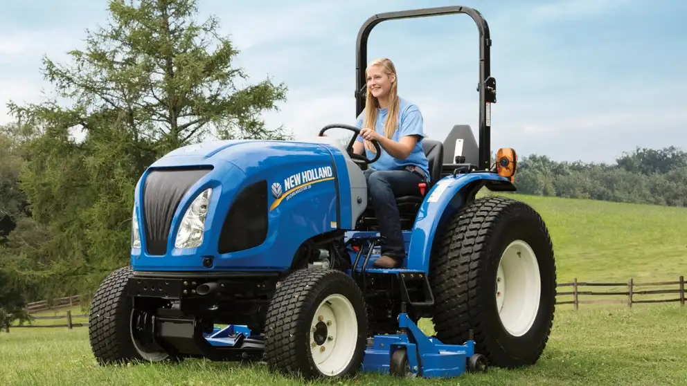 Woman operates a WORKMASTER™ 35 compact tractor