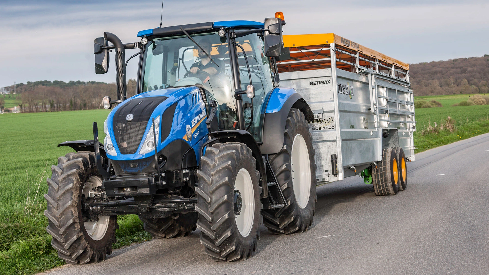 New Holland T5 Dynamic Command & Auto Command tractor transporting goods across the farm