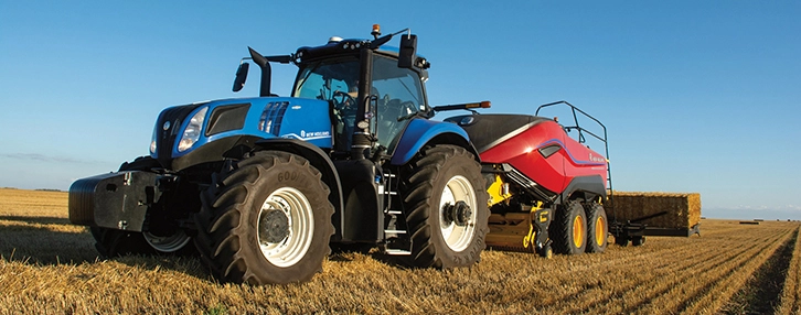 Tractor pulls a BigBaler High Density Large Square Baler